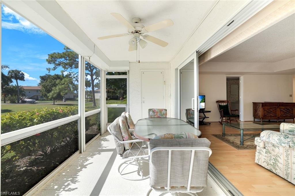 247 Winners Circle, Unit 5 Naples, FL 34112 - Photo 16 of 24 Sunroom / solarium with a ceiling fan and outdoor dining area