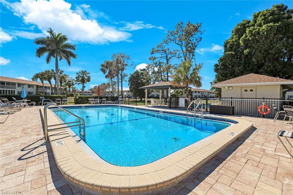 247 Winners Circle, Unit 5 Naples, FL 34112 - Photo 18 of 24 Community pool with a patio and a gazebo