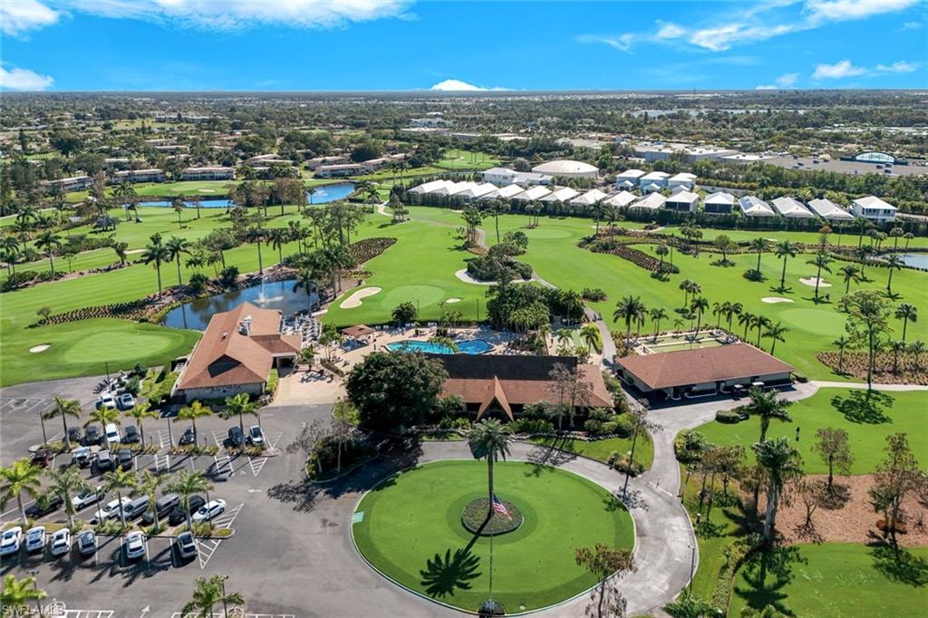 247 Winners Circle, Unit 5 Naples, FL 34112 - Photo 22 of 24 Aerial perspective of suburban area featuring a local golf course and a nearby body of water