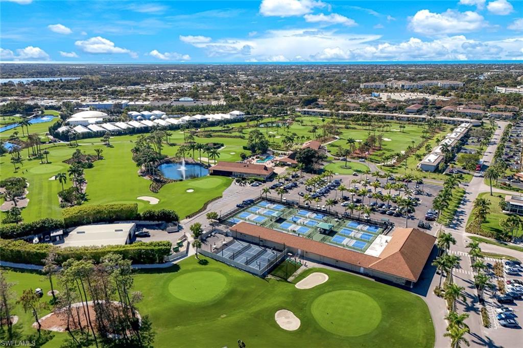 247 Winners Circle, Unit 5 Naples, FL 34112 - Photo 23 of 24 View of property location featuring a golf course, a large body of water, and nearby suburban area