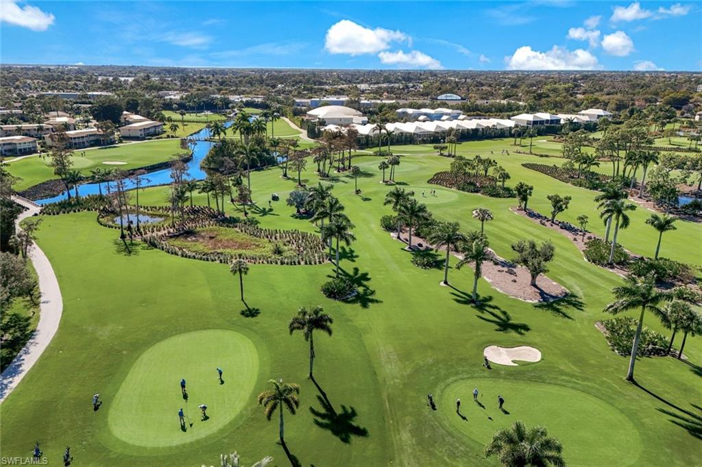 247 Winners Circle, Unit 5 Naples, FL 34112 - Photo 24 of 24 Aerial view of residential area featuring a nearby body of water and a local golf course