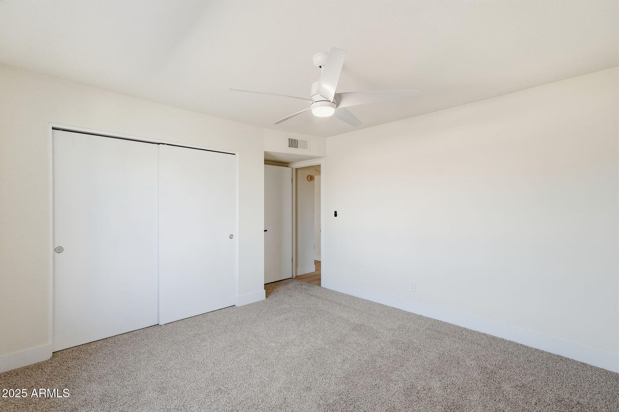 5839 West Hearn Road Glendale, AZ 85306 - Photo 22 of 35 an empty room with a ceiling fan and a window