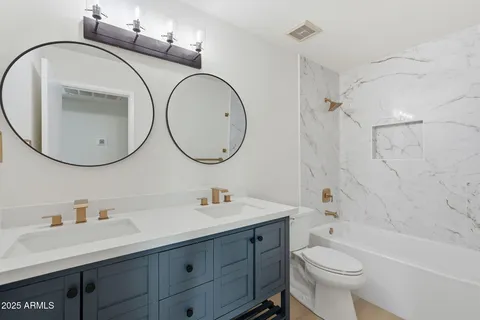 a bathroom with a toilet and shower