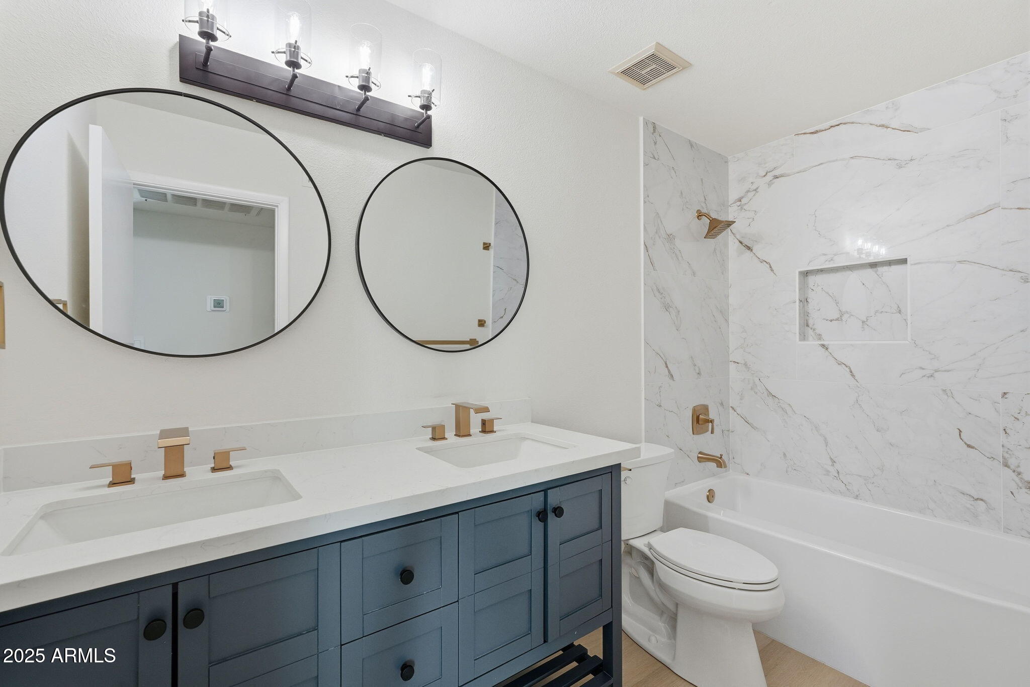 5839 West Hearn Road Glendale, AZ 85306 - Photo 26 of 35 a bathroom with a sink a toilet and a mirror