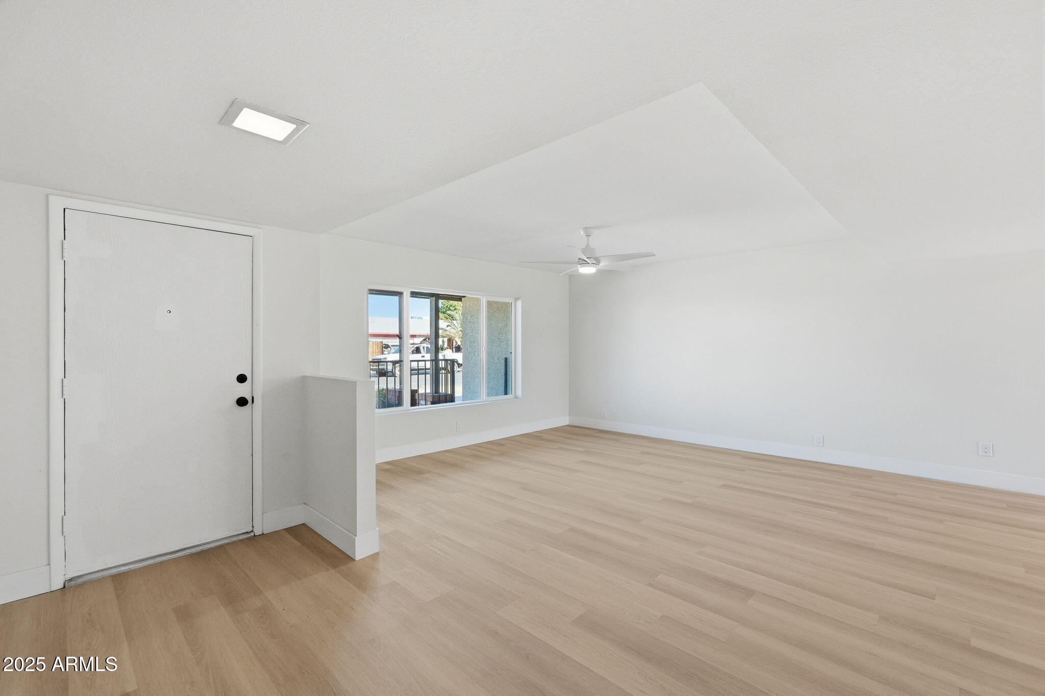 5839 West Hearn Road Glendale, AZ 85306 - Photo 4 of 35 a view of a livingroom with wooden floor and a window