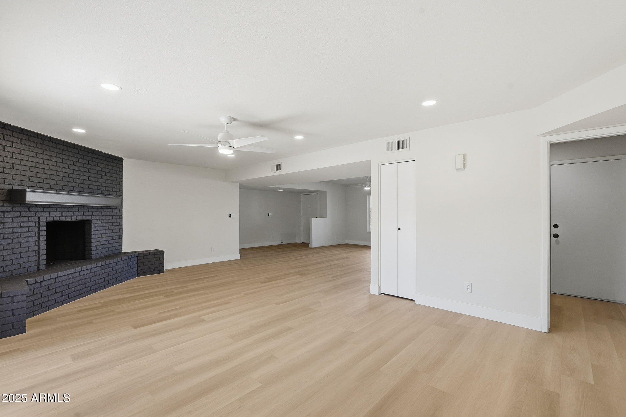5839 West Hearn Road Glendale, AZ 85306 - Photo 9 of 35 a view of an empty room with a fireplace and a window