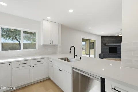 a kitchen with sink a faucet and cabinets