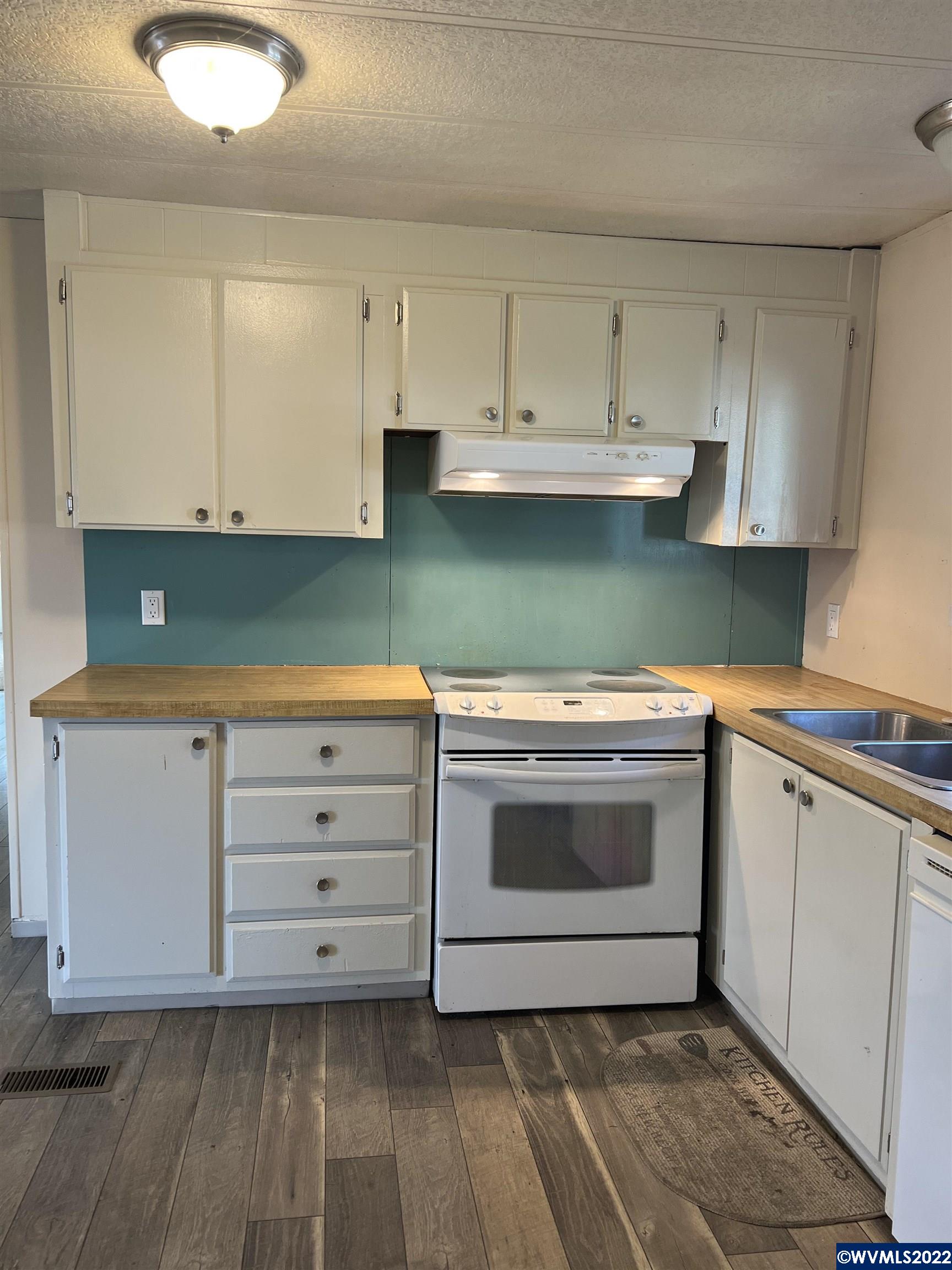 151 Edwards Road South, Unit 68 Monmouth, OR 97361 - Photo 36 of 36 a kitchen with cabinets appliances and a sink