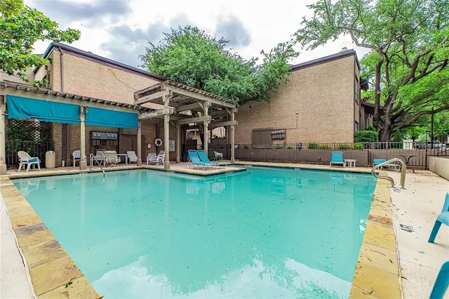 a view of a patio with swimming pool table and chairs