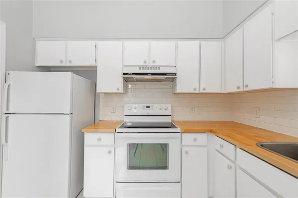 a kitchen with a stove and a refrigerator