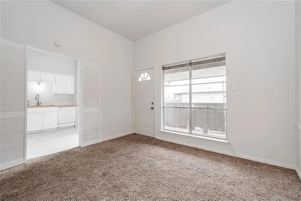 an empty room with windows and closet