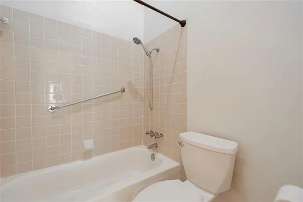 a bathroom with a toilet and shower