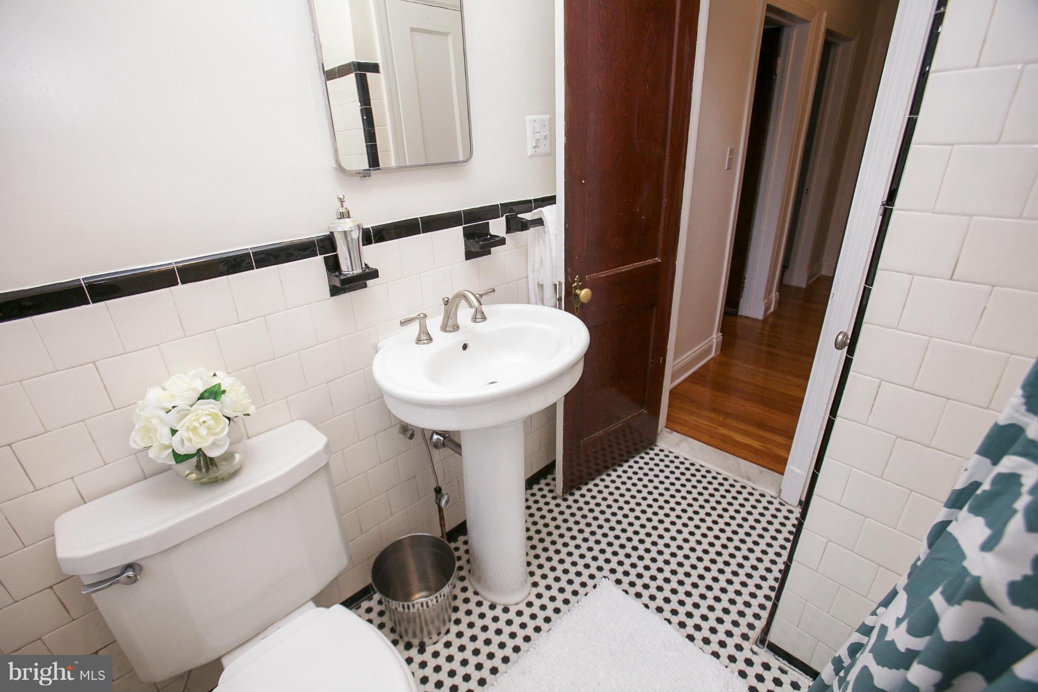 309 Overbrook Road Baltimore, MD 21212 - Photo 11 of 26 a bathroom with a sink toilet and mirror