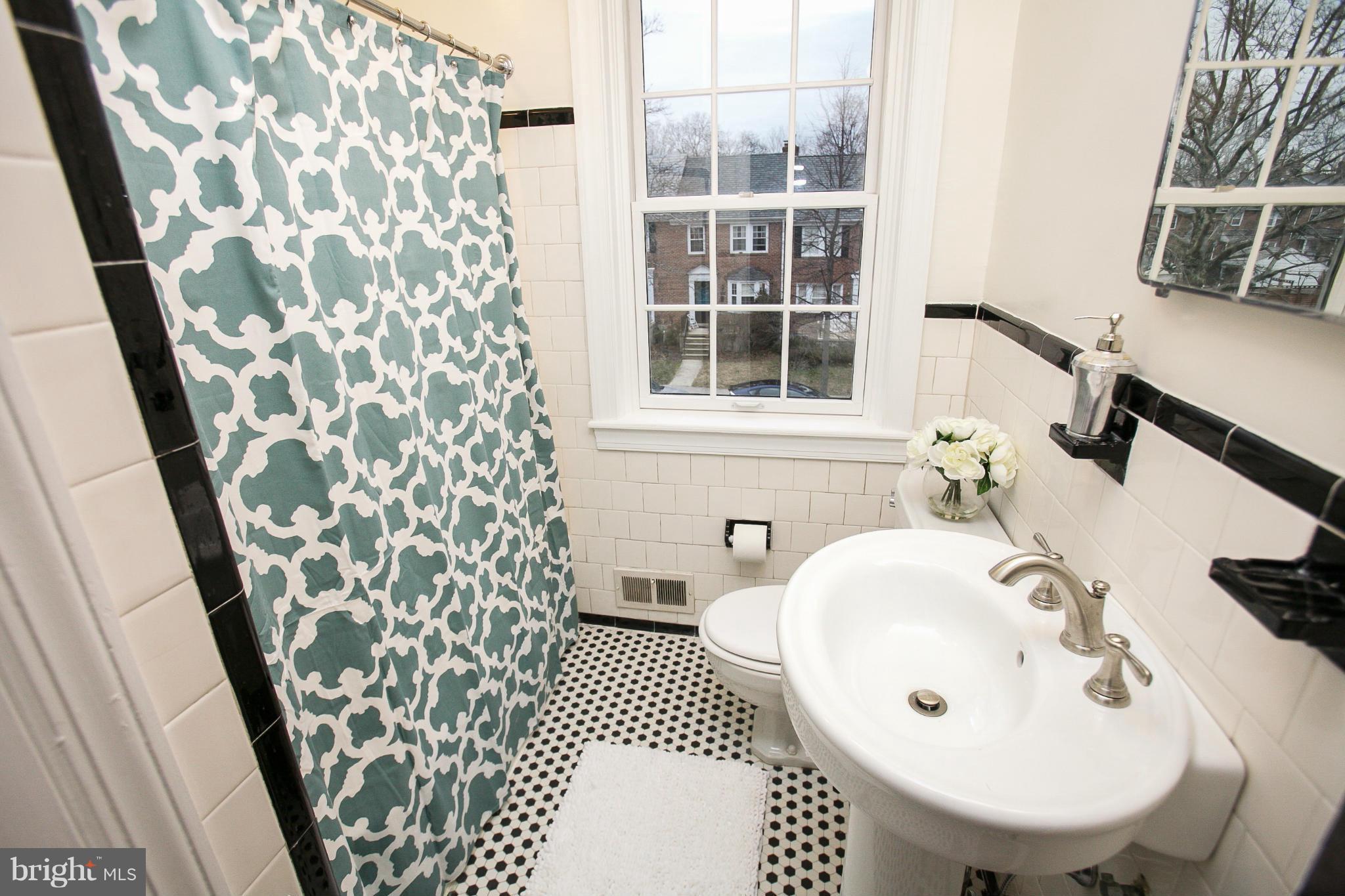 309 Overbrook Road Baltimore, MD 21212 - Photo 12 of 26 a bathroom with a sink and a mirror