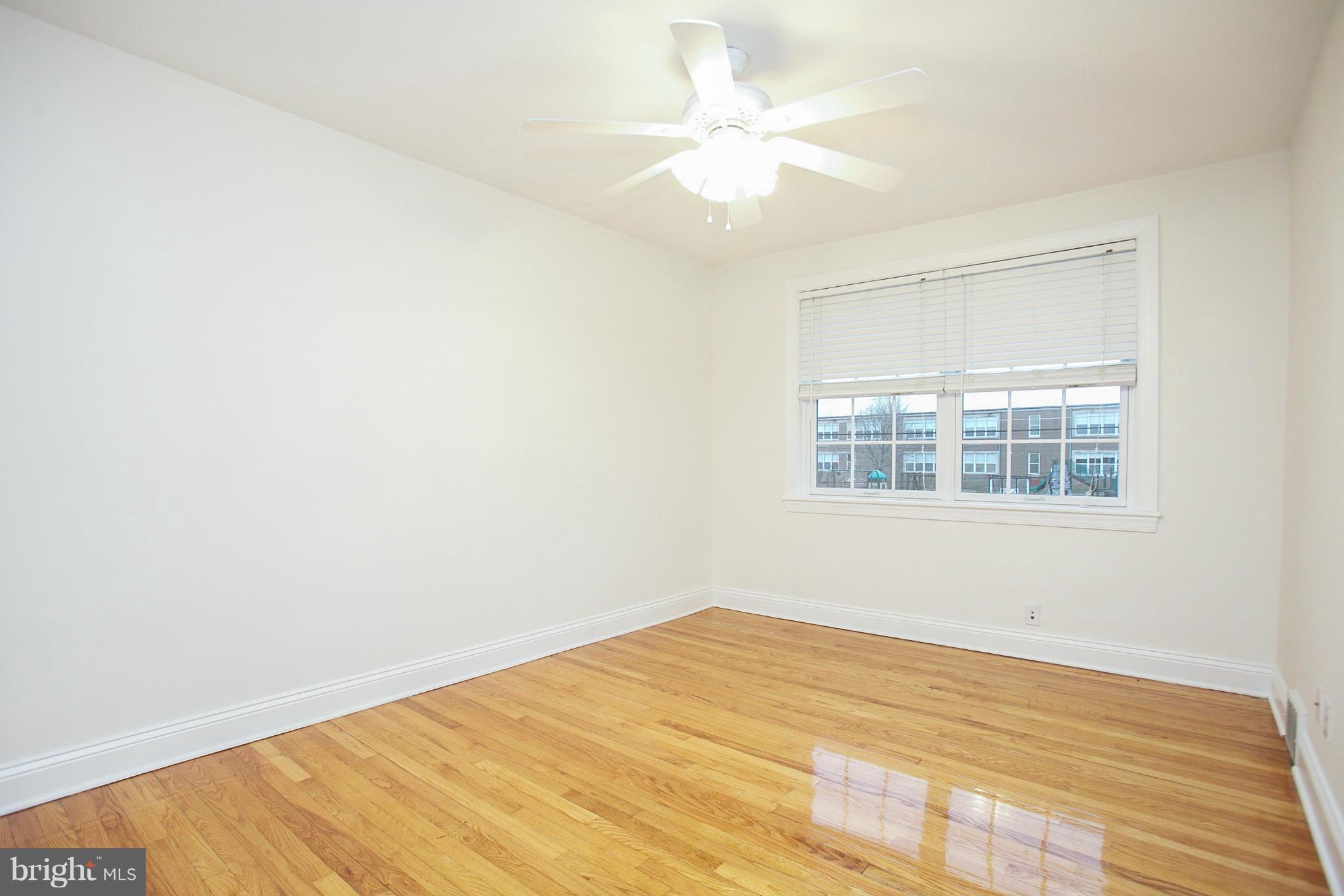 309 Overbrook Road Baltimore, MD 21212 - Photo 17 of 26 a view of an empty room with wooden floor and a window