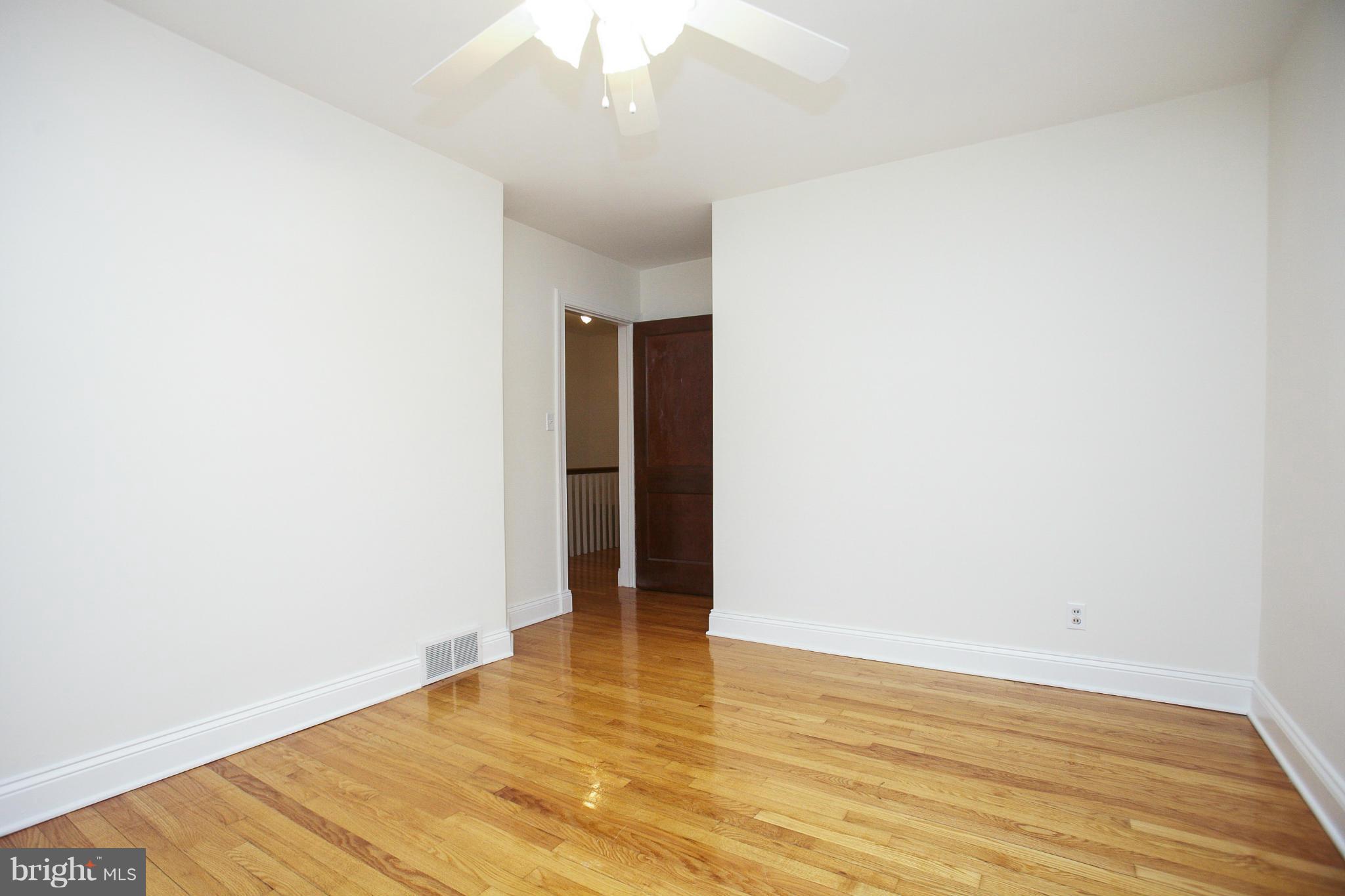 309 Overbrook Road Baltimore, MD 21212 - Photo 18 of 26 a view of an empty room with wooden floor