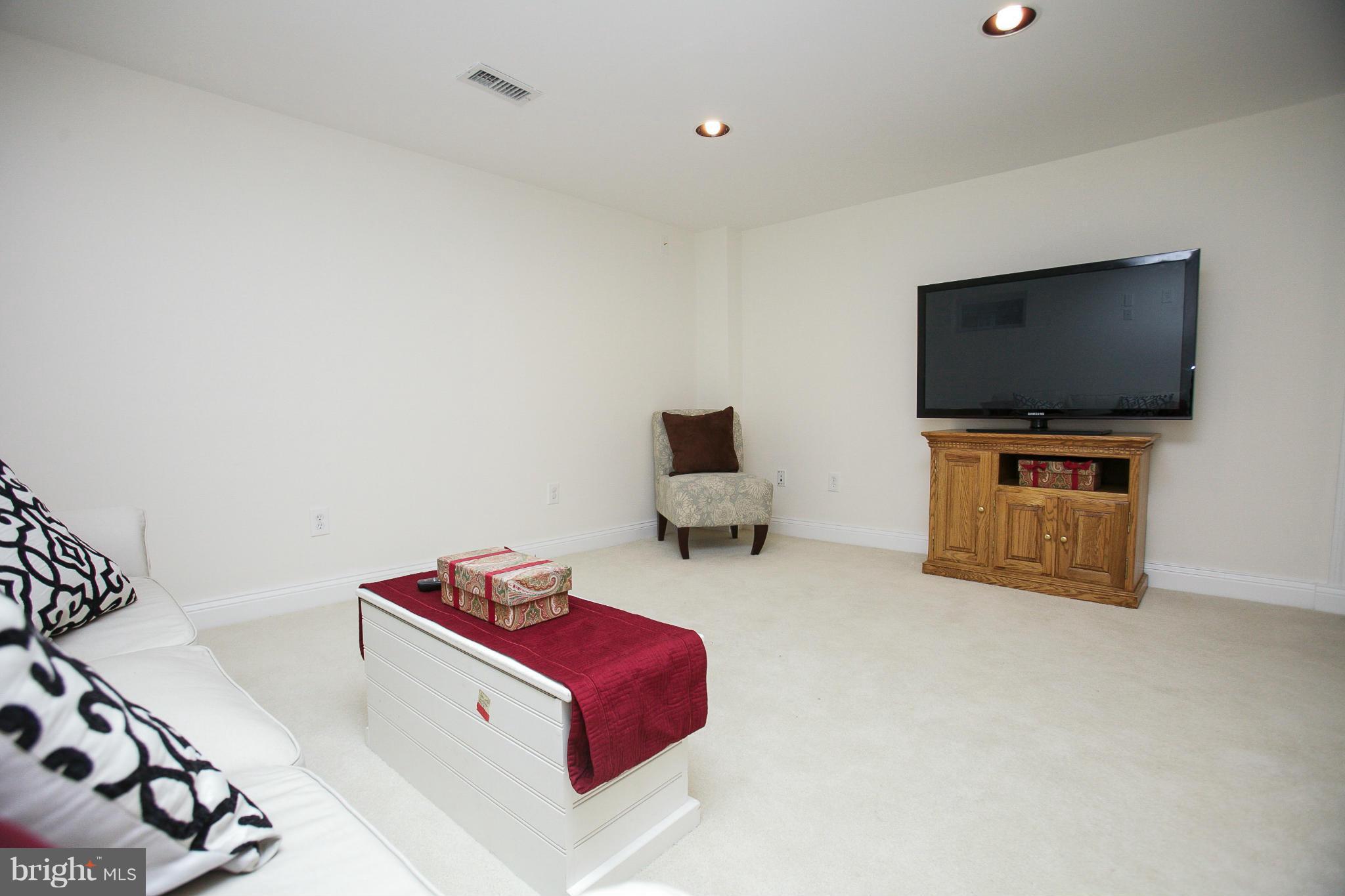 309 Overbrook Road Baltimore, MD 21212 - Photo 21 of 26 a living room with furniture and a flat screen tv