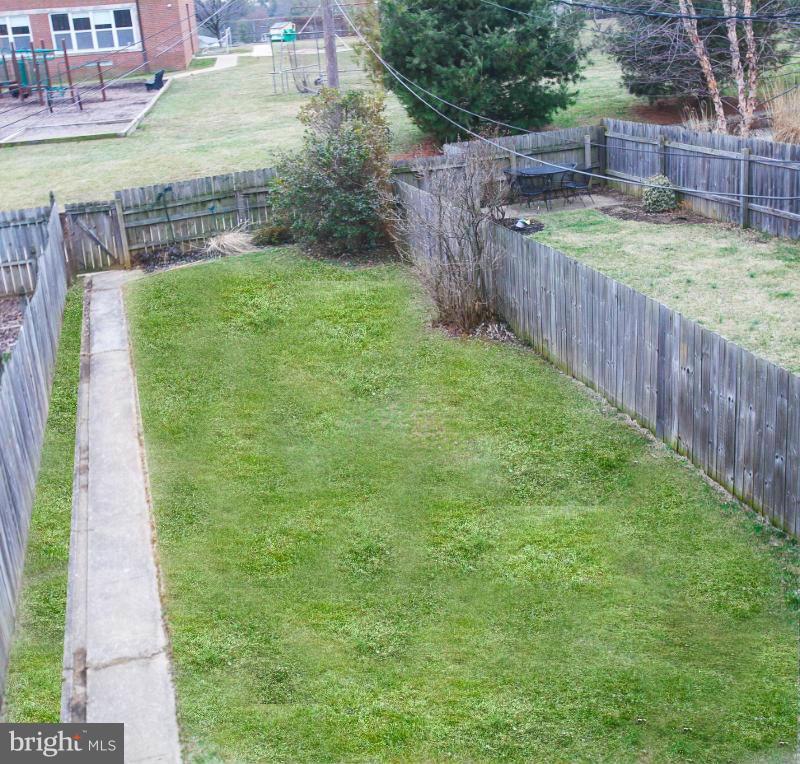 309 Overbrook Road Baltimore, MD 21212 - Photo 25 of 26 a view of a backyard with a wooden fence