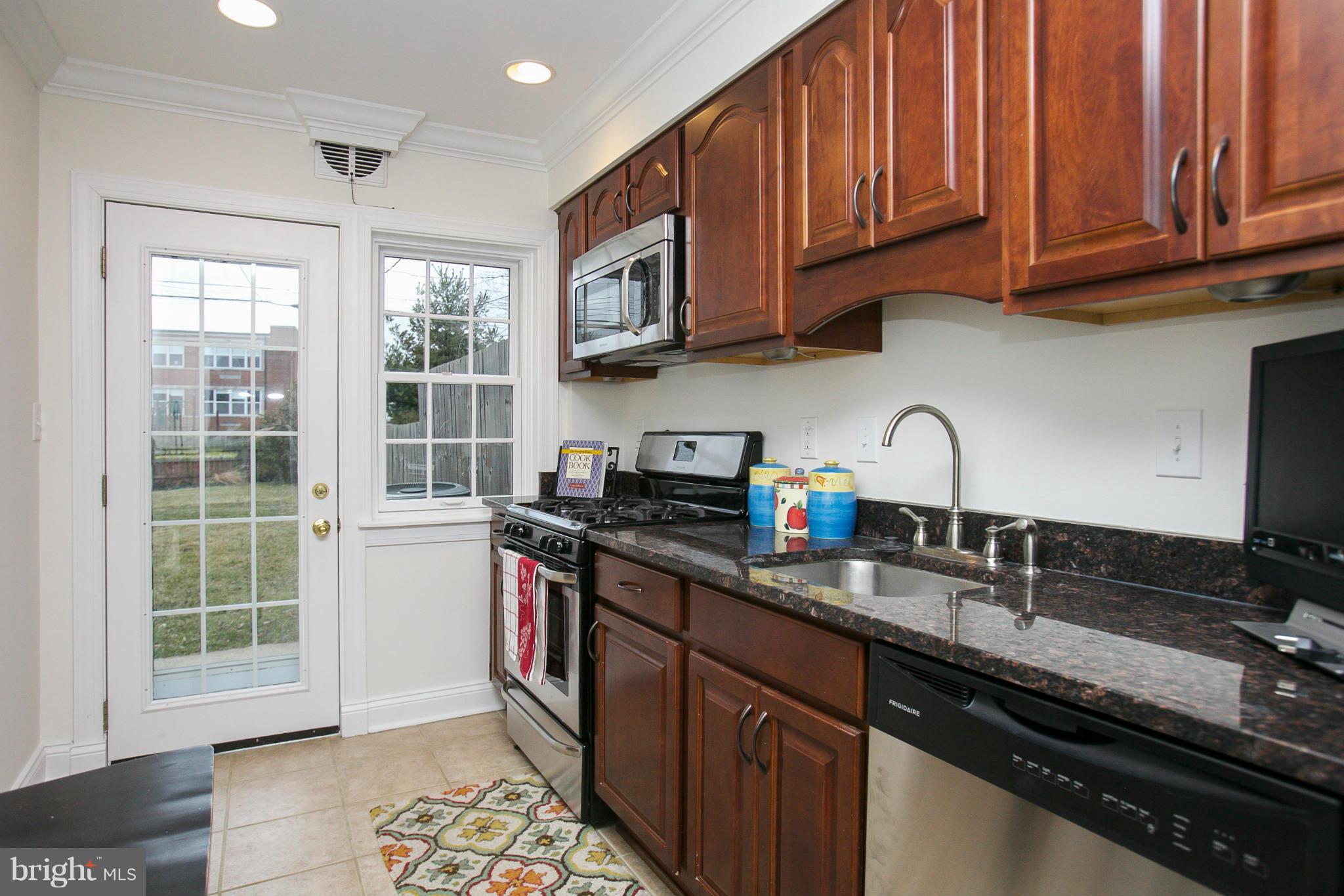 309 Overbrook Road Baltimore, MD 21212 - Photo 7 of 26 a kitchen with stainless steel appliances granite countertop a sink stove and cabinets
