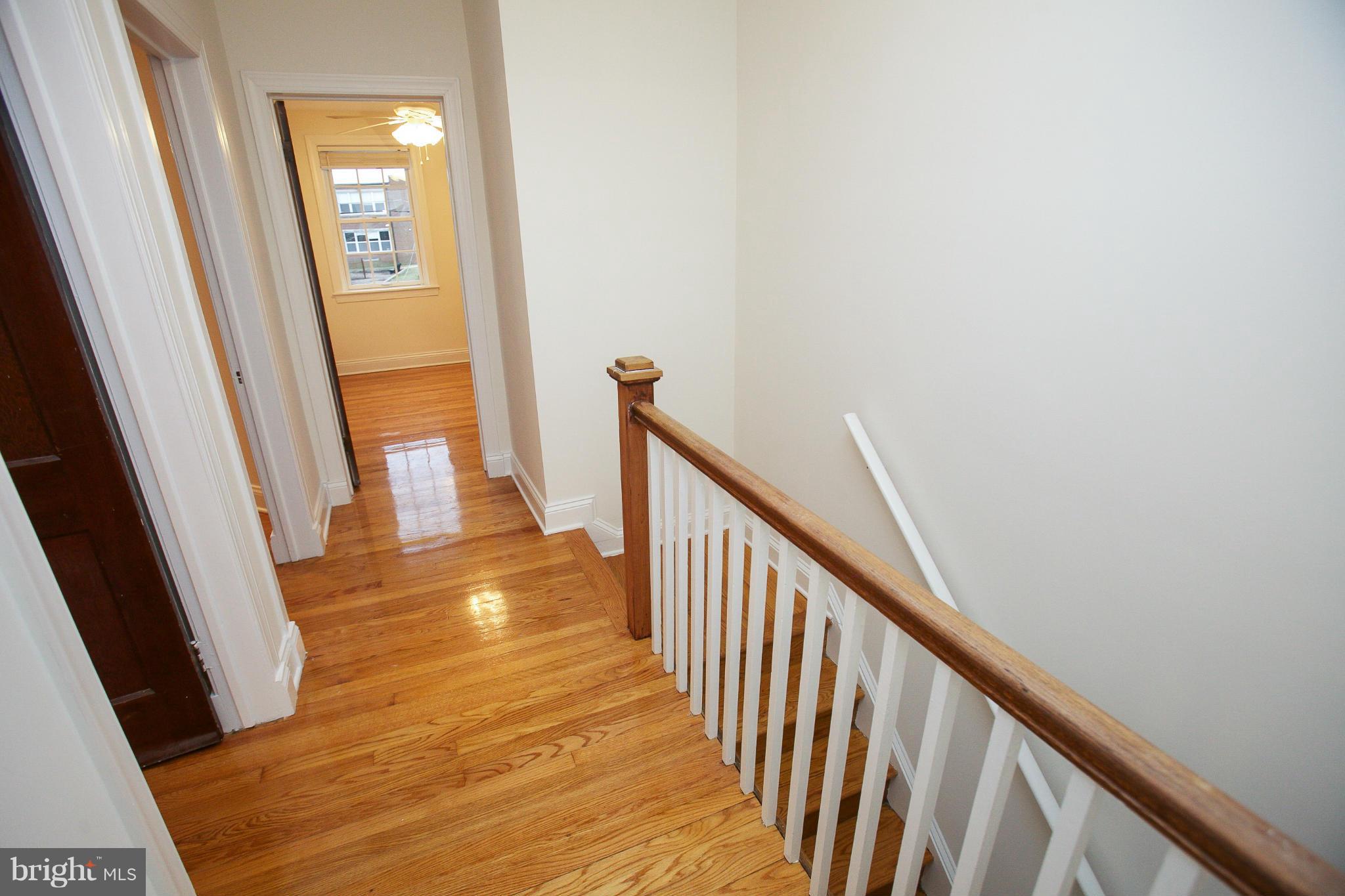 309 Overbrook Road Baltimore, MD 21212 - Photo 9 of 26 a view of a hallway with wooden floor and staircase