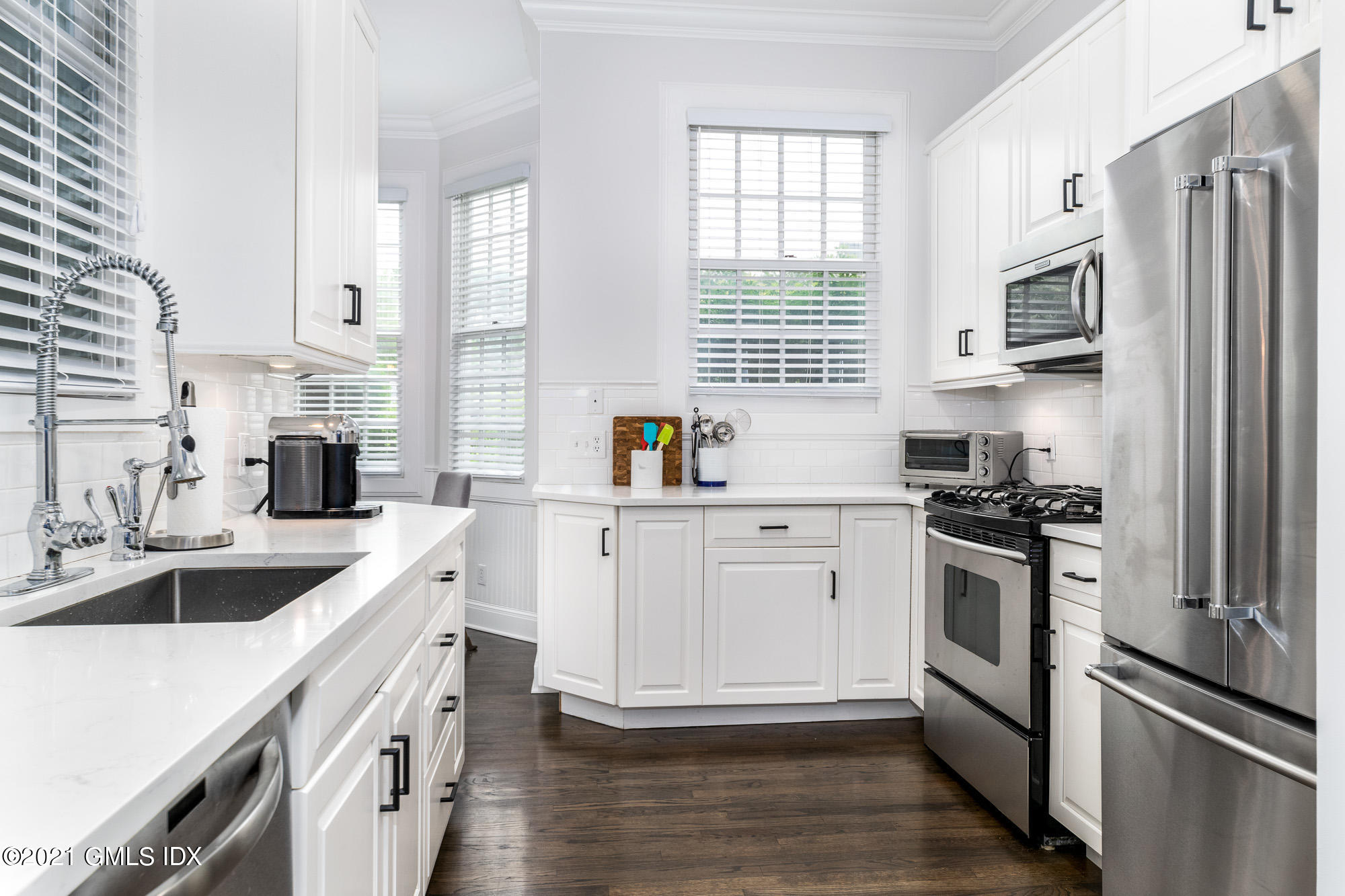 48 Spring Street, Unit 2 Greenwich, CT 06830 - Photo 13 of 36 a kitchen with stainless steel appliances white cabinets and a sink