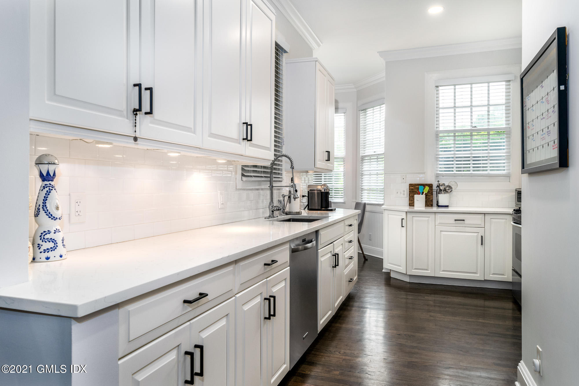 48 Spring Street, Unit 2 Greenwich, CT 06830 - Photo 15 of 36 a kitchen with cabinets appliances a sink and a window