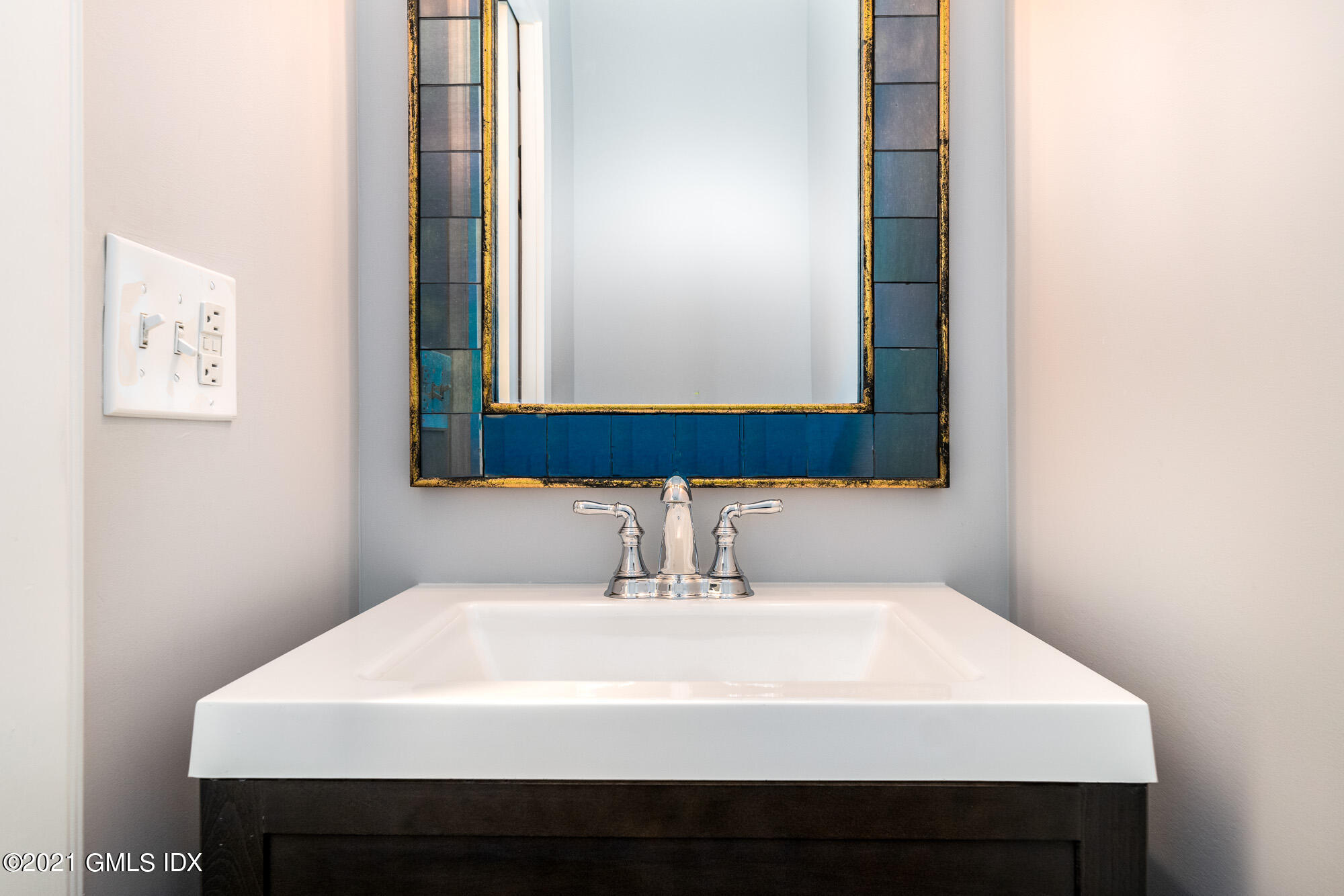 48 Spring Street, Unit 2 Greenwich, CT 06830 - Photo 17 of 36 a bathroom with a sink and a mirror