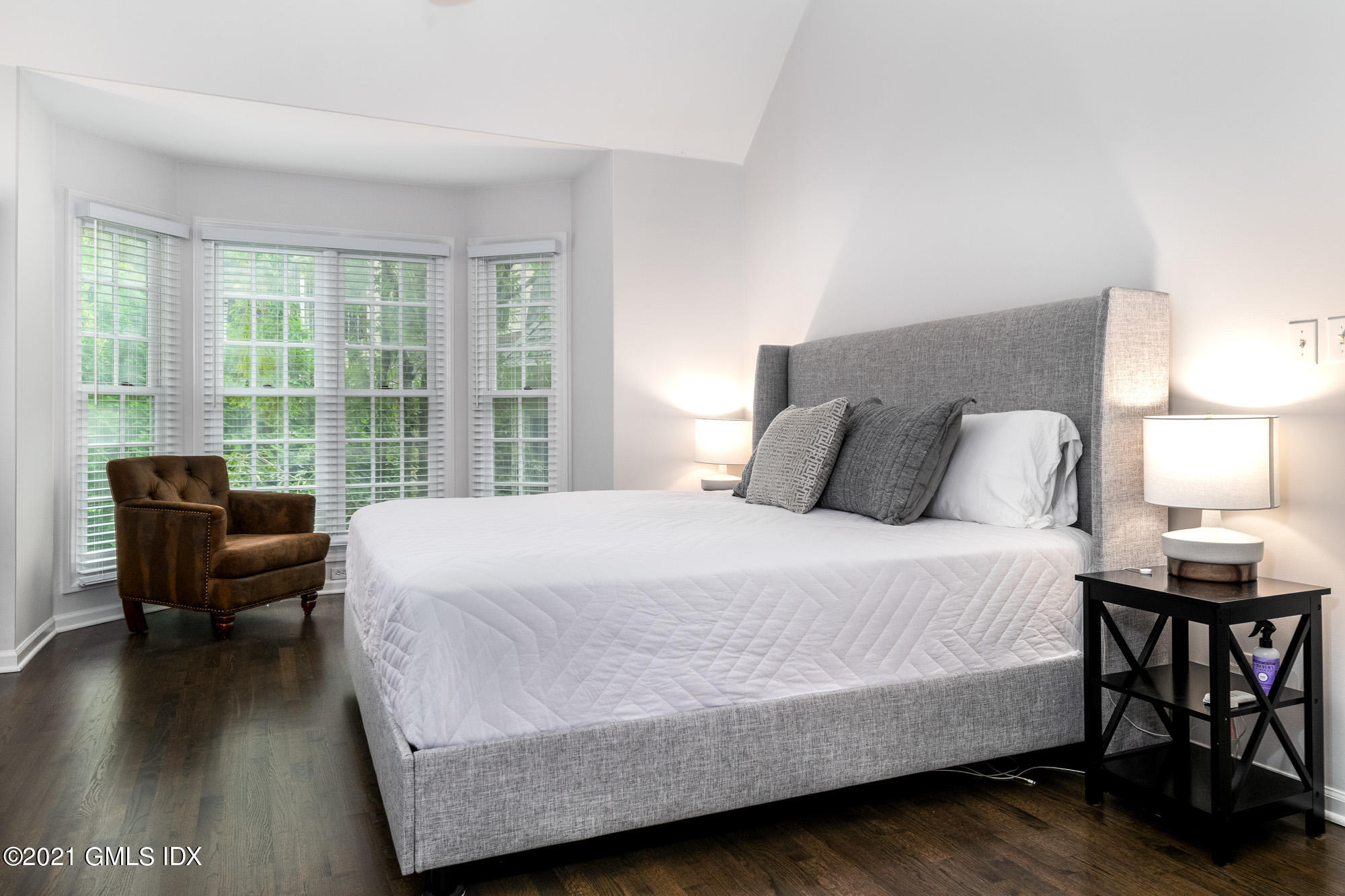 48 Spring Street, Unit 2 Greenwich, CT 06830 - Photo 19 of 36 a bedroom with a bed chair and a window