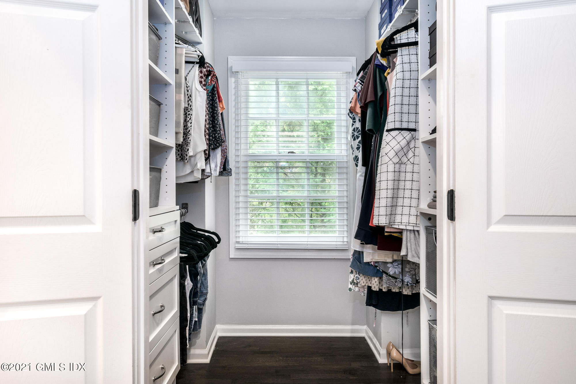 48 Spring Street, Unit 2 Greenwich, CT 06830 - Photo 22 of 36 a view of walk in closet with clothes and shoes