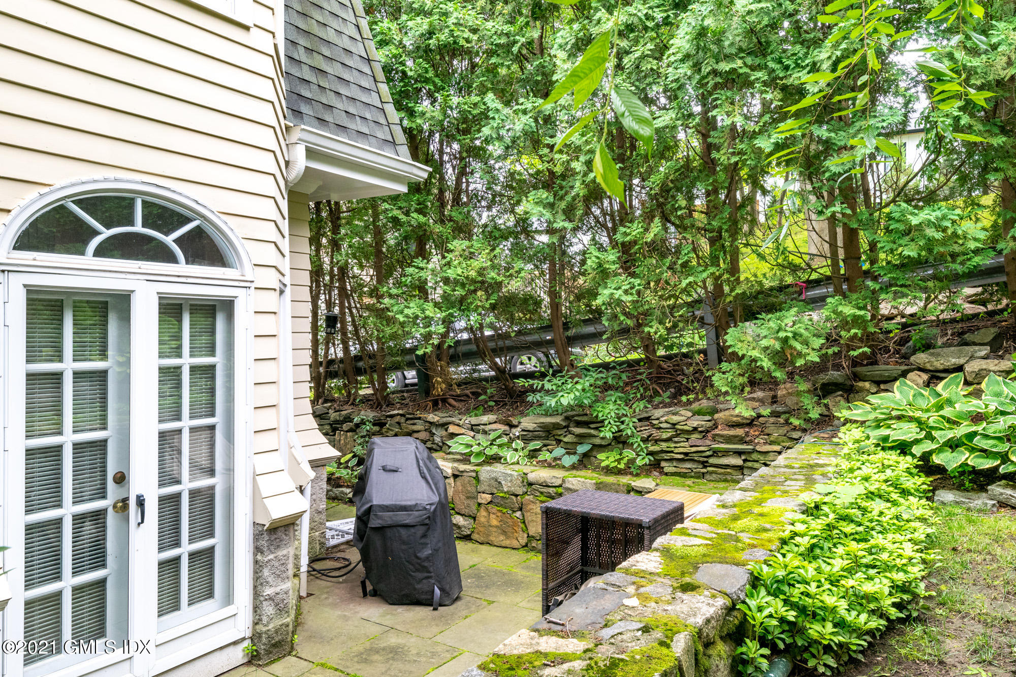 48 Spring Street, Unit 2 Greenwich, CT 06830 - Photo 33 of 36 a view of a patio with table and chairs and potted plants