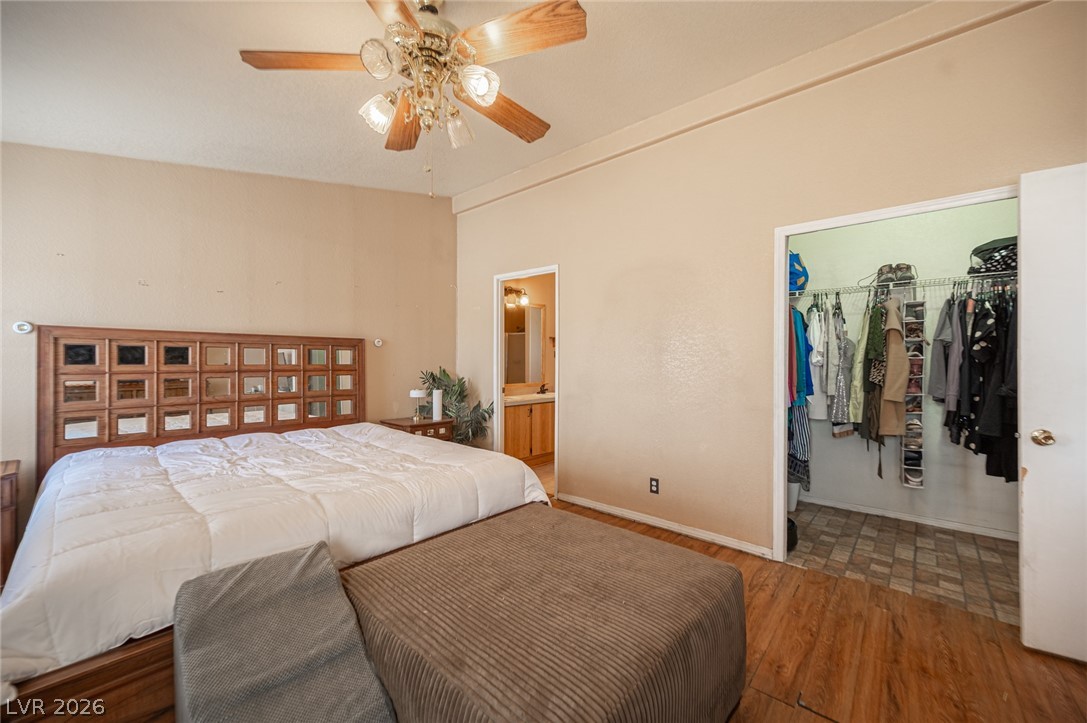 3200 Maple Road Pahrump, NV 89048 - Photo 35 of 53 Restful sleeping quarters feature hardwood flooring and a ceiling fan, with convenient access to a private bath and closet.