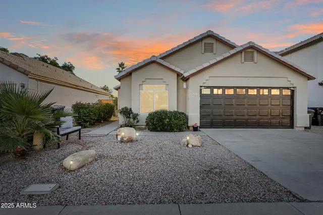 a view of a large house with a big yard and large tree