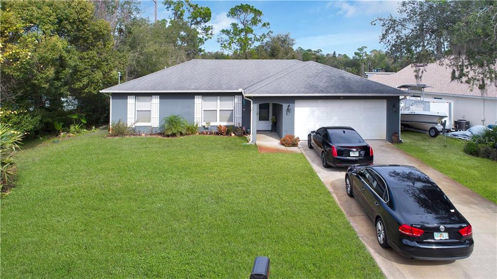 34 Bonita Road DeBary, FL 32713 - Photo 1 of 1 a front view of a house with a garden and parking