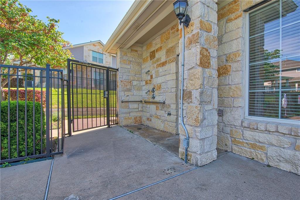 1900 Scofield Ridge Parkway, Unit 5501 Austin, TX 78727 - Photo 15 of 21 An outdoor shower and fenced yard offer practical amenities and accessibility for convenient living.