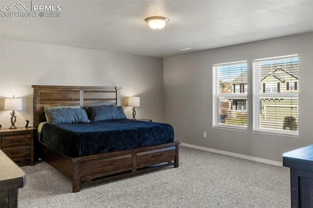 a bedroom with a bed lamp and a window