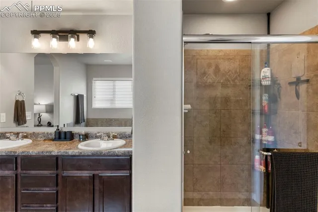 a bathroom with a shower sink and mirror