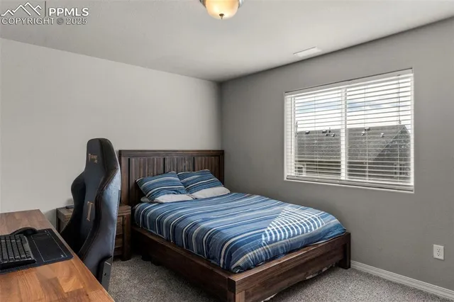 a bedroom with bed and a window