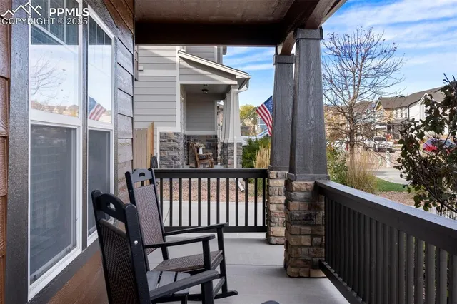 a view of a porch with furniture and garden