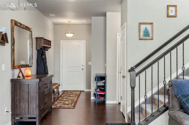 a view of an entryway with wooden floor and stairs