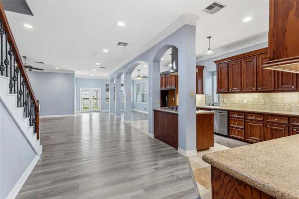 a kitchen with stainless steel appliances granite countertop a stove a sink and a refrigerator