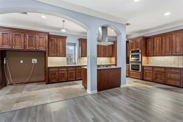 a kitchen with stainless steel appliances granite countertop a refrigerator and a sink