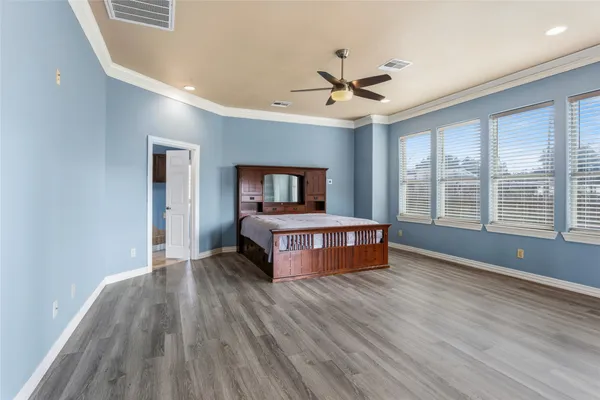 a bedroom with a large bed and a chandelier