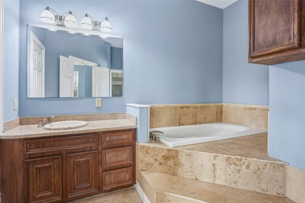 a bathroom with a tub and shower