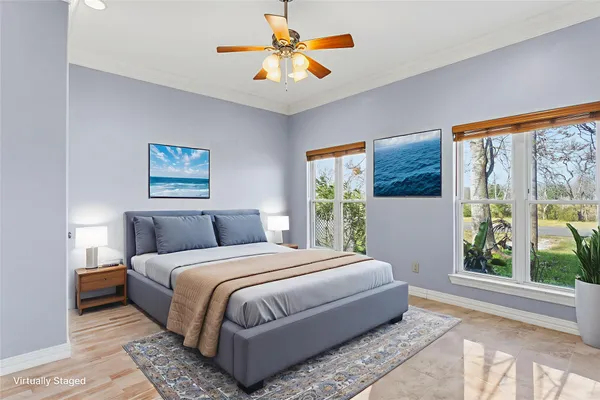 a living room with furniture a window and a potted plant