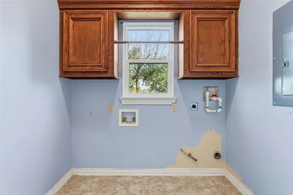 a view of an empty room with wooden floor and a ceiling fan