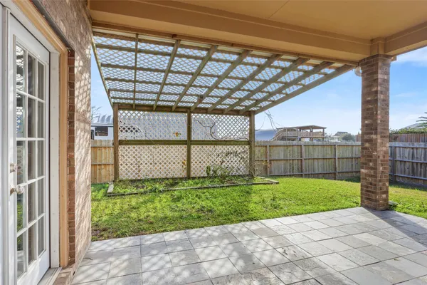 a view of a house with a big yard and large tree