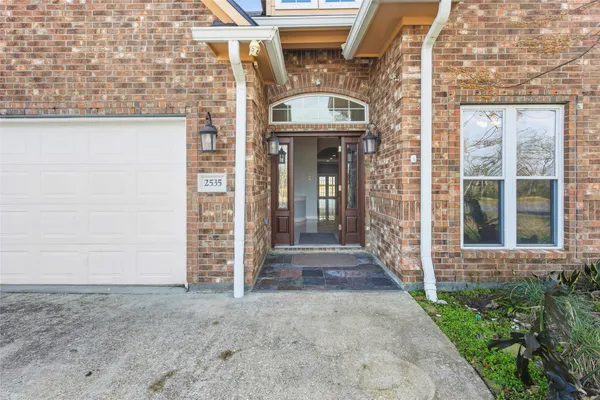 a view of a brick house with large windows