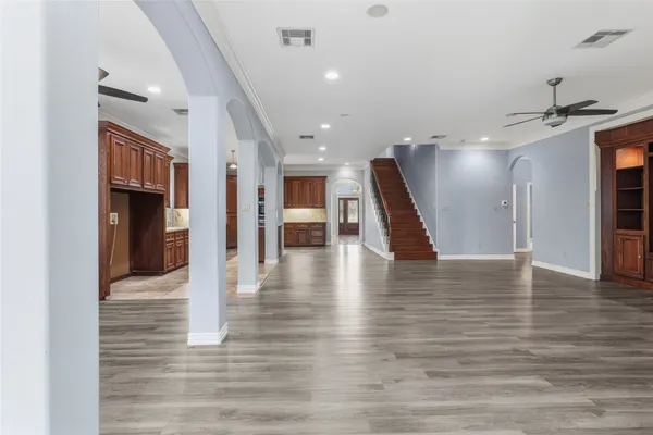 a kitchen with stainless steel appliances granite countertop a refrigerator a stove and a wooden floors