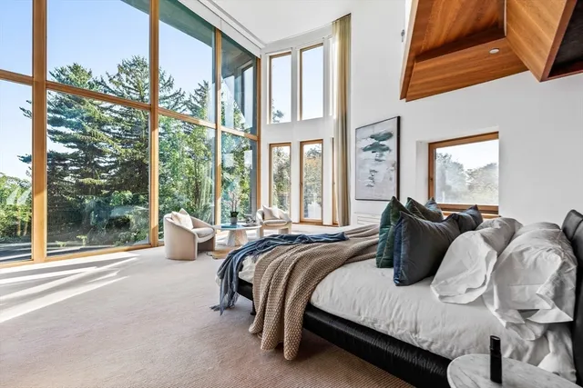 a bed sitting in a bedroom next to a window