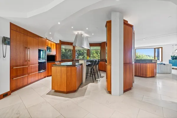 a view of kitchen with furniture and refrigerator